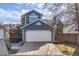 Charming home featuring a two-car garage, blue siding, and a neatly maintained front yard at 717 Walden Ct, Highlands Ranch, CO 80126