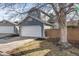 Charming home featuring a two-car garage, blue siding, and a neatly maintained front yard at 717 Walden Ct, Highlands Ranch, CO 80126