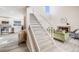 Open-concept living space featuring a modern fireplace, kitchen, wood-look floors, and a staircase at 717 Walden Ct, Highlands Ranch, CO 80126