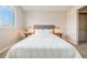 Comfortable bedroom with a cozy bed, soft lighting, two bedside tables, and a large window at 717 Walden Ct, Highlands Ranch, CO 80126