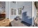 Concrete patio with blue siding, sliding glass door and access to the backyard at 717 Walden Ct, Highlands Ranch, CO 80126