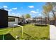 A spacious, green backyard with a patio, trampoline, and soccer goal offering plenty of room for recreation at 4895 E Arizona Ave, Denver, CO 80246