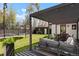A spacious backyard featuring a covered patio, a trampoline and a small garden shed, perfect for outdoor activities at 4895 E Arizona Ave, Denver, CO 80246