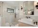 Bright bathroom featuring light wood vanity, walk in shower and black fixtures at 4895 E Arizona Ave, Denver, CO 80246