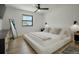 Bright bedroom with a modern ceiling fan and minimalist decor at 4895 E Arizona Ave, Denver, CO 80246