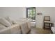 Cozy bedroom with a large window, closet, drawers, and wood flooring at 4895 E Arizona Ave, Denver, CO 80246