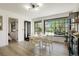 Inviting dining area with a round table, natural light, and access to a cozy bedroom at 4895 E Arizona Ave, Denver, CO 80246