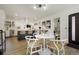 Open-concept dining area featuring a round table and access to the kitchen, creating a cohesive living space at 4895 E Arizona Ave, Denver, CO 80246