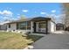 A beautifully maintained home with a modern design, showcasing its pristine lawn and welcoming curb appeal at 4895 E Arizona Ave, Denver, CO 80246