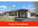 Charming home featuring a well-maintained lawn and inviting front porch seating area at 4895 E Arizona Ave, Denver, CO 80246