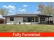 A well-maintained house with large front yard, and stylish exterior presenting a welcoming and comfortable living space at 4895 E Arizona Ave, Denver, CO 80246