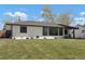 Charming home with well-manicured lawn, modern windows, and inviting curb appeal, showcasing a blend of style and comfort at 4895 E Arizona Ave, Denver, CO 80246