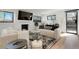 Modern living room with fireplace, flat-screen TV, and lots of natural light at 4895 E Arizona Ave, Denver, CO 80246