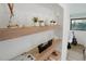 Modern shelving unit displaying decorative items and natural light at 4895 E Arizona Ave, Denver, CO 80246