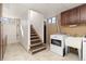 Basement area features a laundry area, stairs, and a window providing natural light at 2434 S Ogden St # 2434-2436, Denver, CO 80210