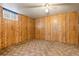 Bedroom featuring paneling, carpet, and a window at 2434 S Ogden St # 2434-2436, Denver, CO 80210