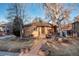 Attractive single-story brick home showcasing a landscaped front yard with mature trees at 2434 S Ogden St # 2434-2436, Denver, CO 80210