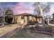 Charming brick home featuring a well-manicured front yard and inviting entrance at 2434 S Ogden St # 2434-2436, Denver, CO 80210