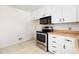 Kitchen with stainless steel oven and microwave, light counter tops, and patterned tile floor at 2434 S Ogden St # 2434-2436, Denver, CO 80210