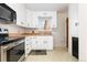 Bright kitchen featuring stainless steel appliances, white cabinets, and tile floor at 2434 S Ogden St # 2434-2436, Denver, CO 80210
