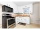 Charming kitchen featuring white cabinets, stainless steel appliances, and a garden window at 2434 S Ogden St # 2434-2436, Denver, CO 80210