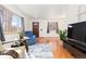Sunlit living area featuring gleaming hardwood floors, neutral paint, and a cozy atmosphere at 2434 S Ogden St # 2434-2436, Denver, CO 80210