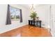 Bright dining area with hardwood floors, neutral walls, and a large window for natural light at 2434 S Ogden St # 2434-2436, Denver, CO 80210