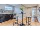 Stylish bar area with dark cabinetry, mosaic tile backsplash, and modern bar stools at 2540 Xavier St, Denver, CO 80212