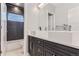 Modern bathroom featuring double sinks, sleek dark cabinetry, and a tiled shower/tub at 2540 Xavier St, Denver, CO 80212