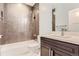 Well-lit bathroom with dark vanity, subway tile, and a modern shower head at 2540 Xavier St, Denver, CO 80212