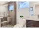 Modern bathroom with a glass-enclosed shower, decorative tiles, and sleek vanity at 2540 Xavier St, Denver, CO 80212