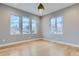 Bright, airy bedroom with natural light from three windows and light hardwood flooring at 2540 Xavier St, Denver, CO 80212
