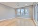 Bright bedroom with light hardwood floors, three windows, and a ceiling fan at 2540 Xavier St, Denver, CO 80212