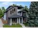 Modern two-story home boasts mixed material facade, covered entry, and manicured landscaping at 2540 Xavier St, Denver, CO 80212
