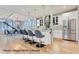 Bright, open kitchen with white cabinetry, stainless steel appliances and a large island with seating at 2540 Xavier St, Denver, CO 80212