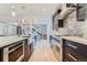 Gourmet kitchen featuring stainless steel appliances, dark cabinets, and a view into the light-filled living spaces at 2540 Xavier St, Denver, CO 80212