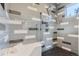 Contemporary shower features stylish gray tiling, a built-in seat, and modern fixtures at 2540 Xavier St, Denver, CO 80212