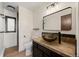 Bathroom features a modern vanity, tile backsplash, dark wood cabinets, and framed mirror at 33379 Buffalo Park Rd, Evergreen, CO 80439