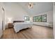 Comfortable main bedroom featuring vaulted ceilings, large windows, and wood floors at 33379 Buffalo Park Rd, Evergreen, CO 80439