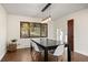 Well-lit dining room with a modern table set and a large window overlooking trees at 33379 Buffalo Park Rd, Evergreen, CO 80439
