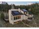 Stunning contemporary home with solar panels and inviting outdoor seating areas at 33379 Buffalo Park Rd, Evergreen, CO 80439