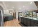 Open kitchen boasts stainless steel appliances and great natural light with sliding glass door access to the outside at 33379 Buffalo Park Rd, Evergreen, CO 80439