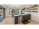Kitchen island with stainless steel dishwasher, great view outside the window, and open storage shelves at 33379 Buffalo Park Rd, Evergreen, CO 80439