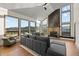 Inviting living room with a stone fireplace, large windows showcasing mountain views, and cozy seating at 33379 Buffalo Park Rd, Evergreen, CO 80439