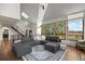 Bright, modern living room with high ceilings, large windows, and a comfortable sectional sofa at 33379 Buffalo Park Rd, Evergreen, CO 80439