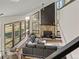 Bright living room with large windows, vaulted ceilings, wood burning fireplace, and hardwood floors at 33379 Buffalo Park Rd, Evergreen, CO 80439
