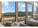 Scenic mountain views framed by large windows in a comfortable living room setting at 33379 Buffalo Park Rd, Evergreen, CO 80439