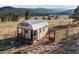Scenic shed with a porch in a field surrounded by mountain views at 33379 Buffalo Park Rd, Evergreen, CO 80439