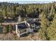 Aerial view of a home showcasing solar panels, outdoor seating, and natural surroundings at 33379 Buffalo Park Rd, Evergreen, CO 80439