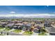Expansive aerial view showcases a neighborhood with various homes and mountain views in the distance on a clear, sunny day at 12941 Delaware St, Westminster, CO 80234